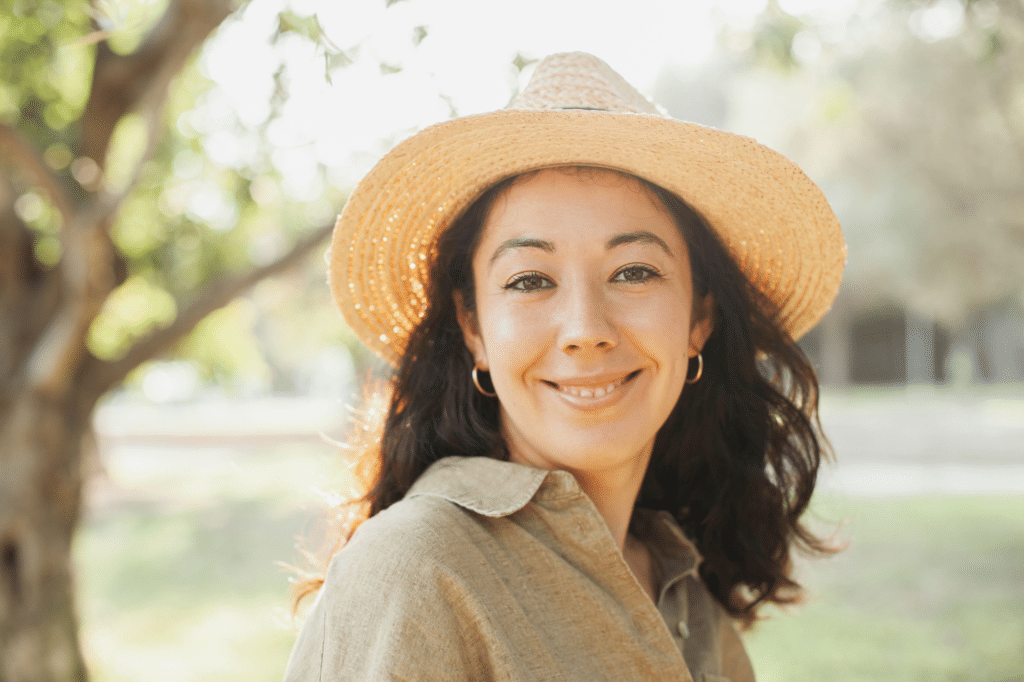 Smiling woman in a straw sun hat outdoors