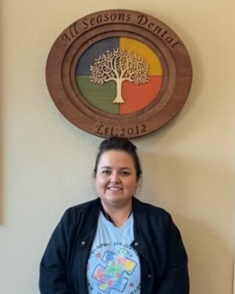 Bernice, RDH, beneath the All Seasons Dental sign